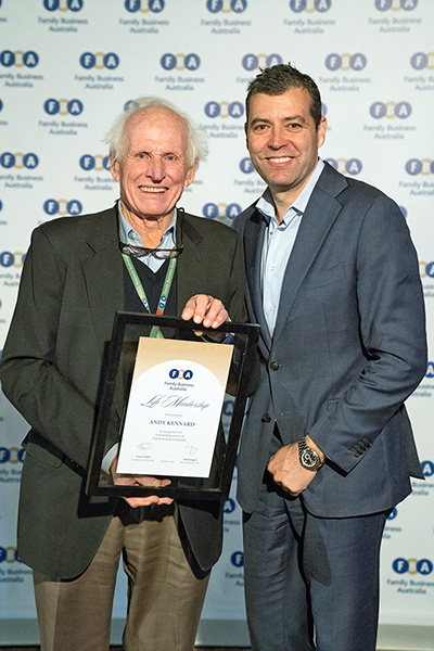 Andy Kennard receives his Life Membership Award from Family business Australia's Greg Griffith.