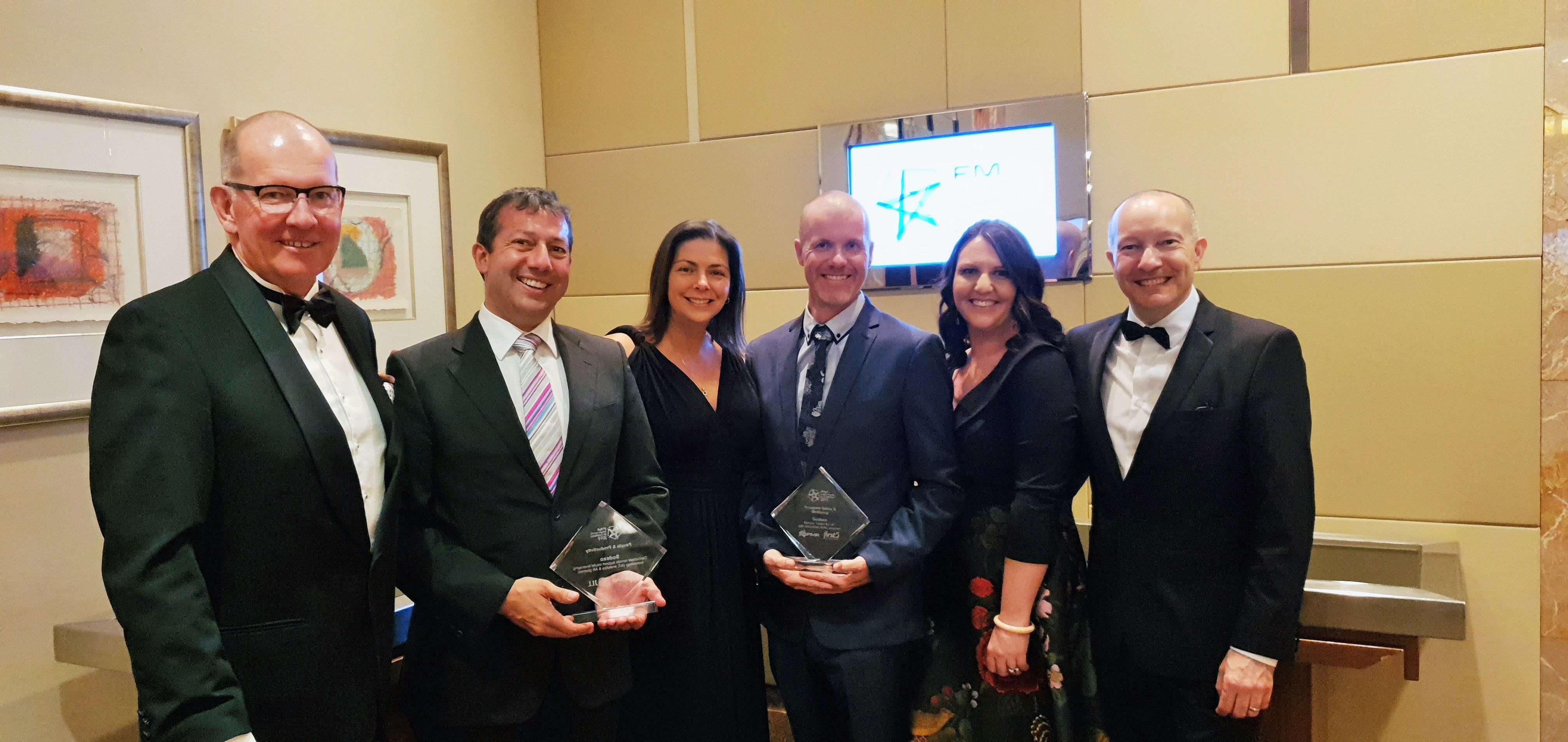 Sodexo team with their two awards at the FM Industry Awards for Excellence.