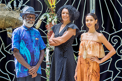 From left are Pormpuraaw artist Sid Bruce Short Joe, CIAF artistic director Janina Harding and model-performer Kristen Fagan. Image: CIAF.