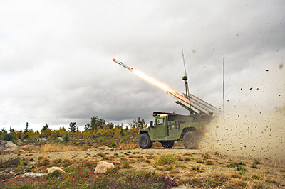 Raytheon NASAMS high mobility launcher firing an AMRAAM missile.