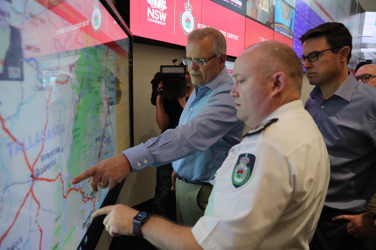 Prime Minister Scott Morrison (left) and Federal Natural Disaster and Emergency Services Minister David Littleproud (right) are brought up to speed on the bushfire situation in late December by NSW Rural Fire Services commissioner Shane Fitzsimmon. Image: PM Office.