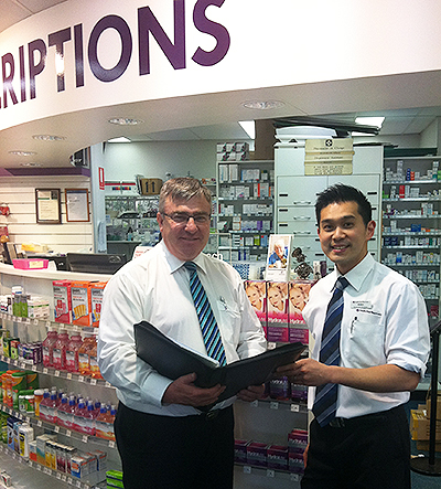 Martin Millane (left) works with Sinnamon Park Pharmacy manager Allen Huang on implementing growth strategies.