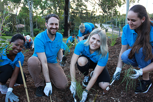 From left are Shashi Nadarajah, Sarah Brown, Mathew Mann and Kat Garrett getting into the spirit of the centennial native tree planting.
